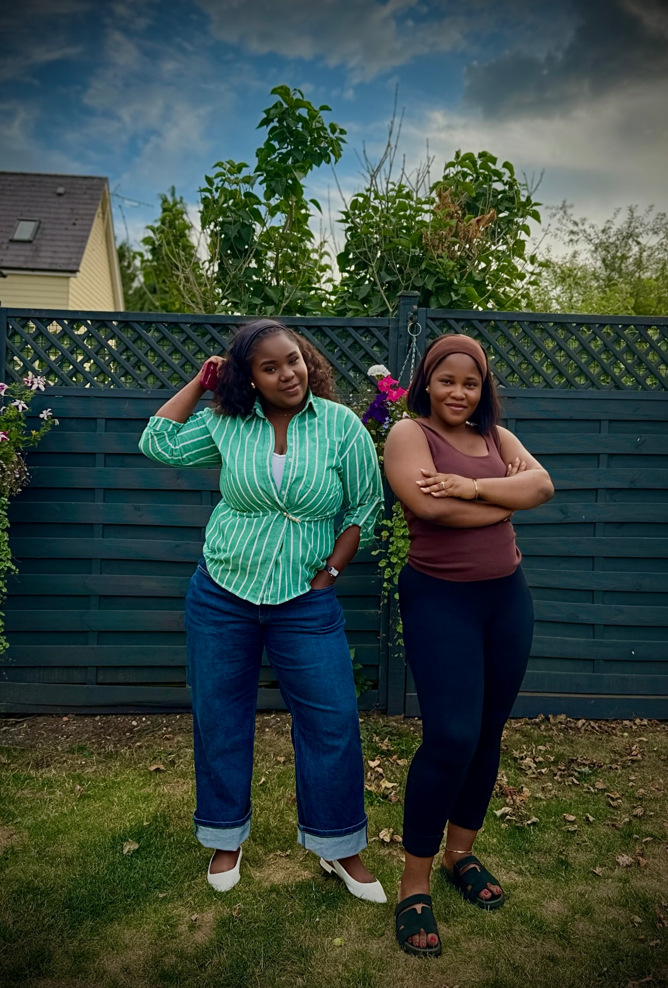 Opeyemi Oloyede and Sarah Agboola standing together in a garden, co-founders of Heal & Become